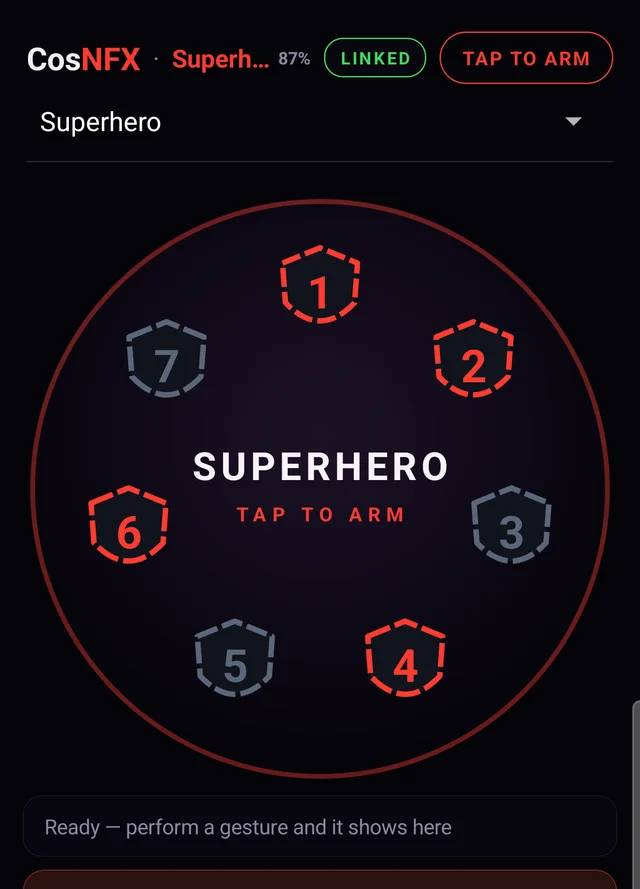 The phone companion showing the Superhero identity linked at 87 percent battery, a tap to arm control, the seven-pad ring, and a status line reading ready, perform a gesture and it shows here.